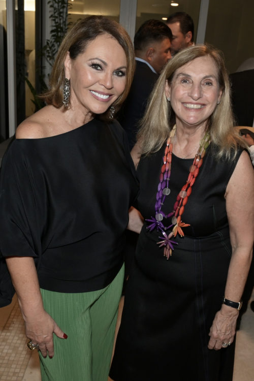 Maria Elena Salinas and Mily De Molina at the 2022 Art Basel Celebration party hosted by Raul and Mily de Molina at the Grand Bay in Key Biscayne