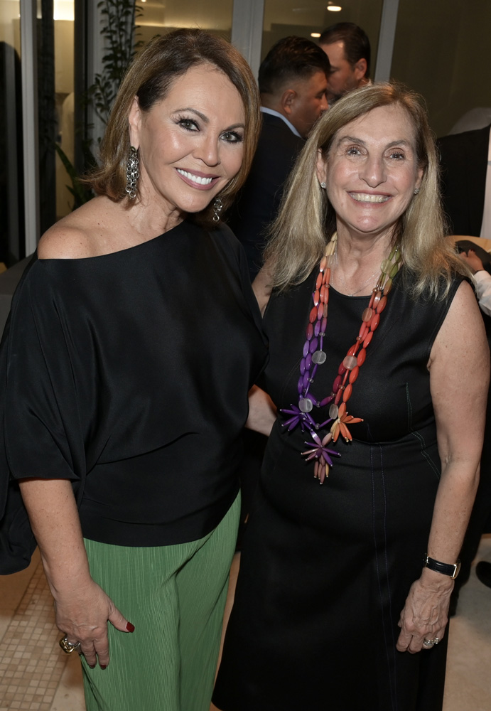 Maria Elena Salinas and Mily De Molina at the 2022 Art Basel Celebration party hosted by Raul and Mily de Molina at the Grand Bay in Key Biscayne