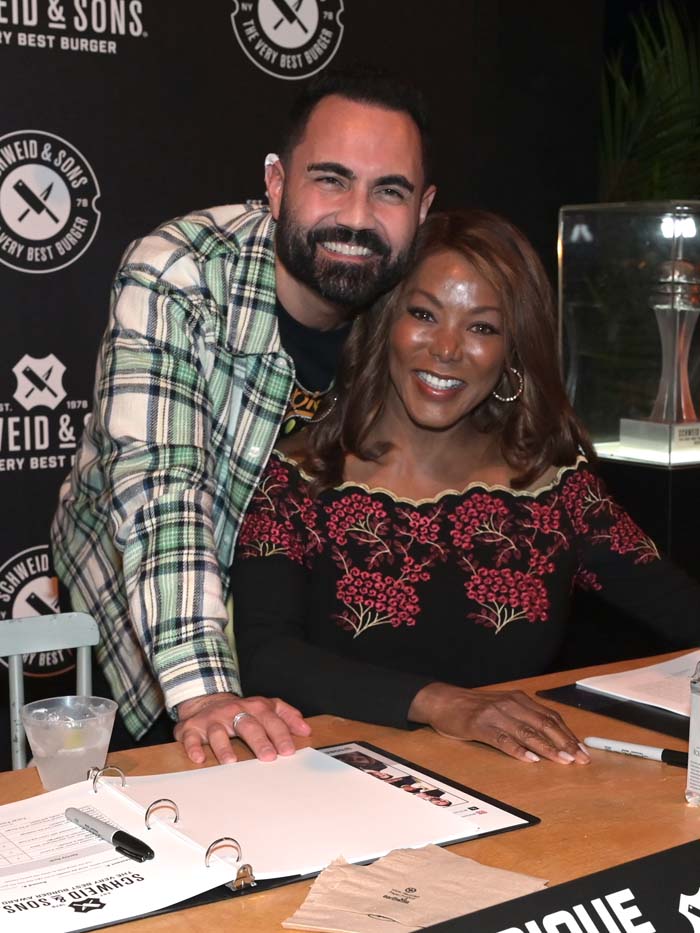 Enrique Santos and NBC 6's Trina Robinson at the South Beach Wine & Food Festival Burger Bash