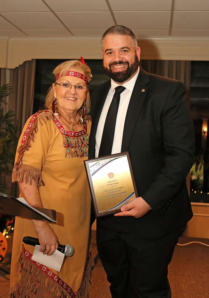 Marjorie Hahn Executive Director  as "Tiger Lily"  presenting award to Honoree Fermin Vazquez, President of Miami Dade College North Campus