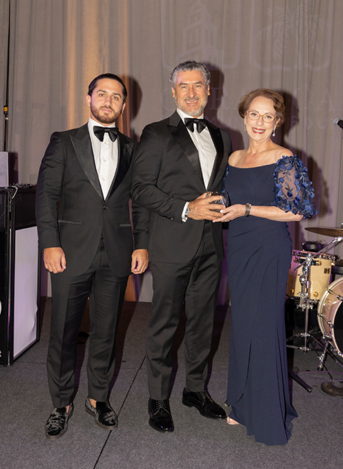 Award Presenter Alirio Torrealba with honoree Lourdes A. Boue representing Baptist Health. At left, Diego Torrealba