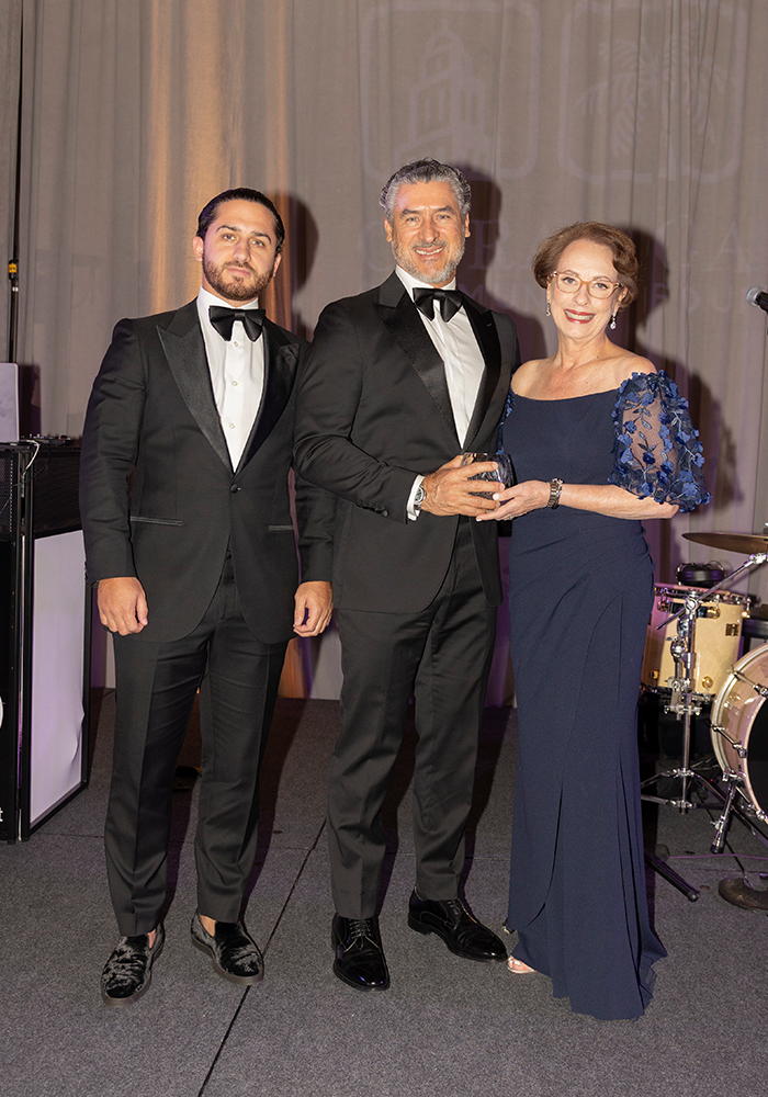 Award Presenter Alirio Torrealba with honoree Lourdes A. Boue representing Baptist Health. At left, Diego Torrealba